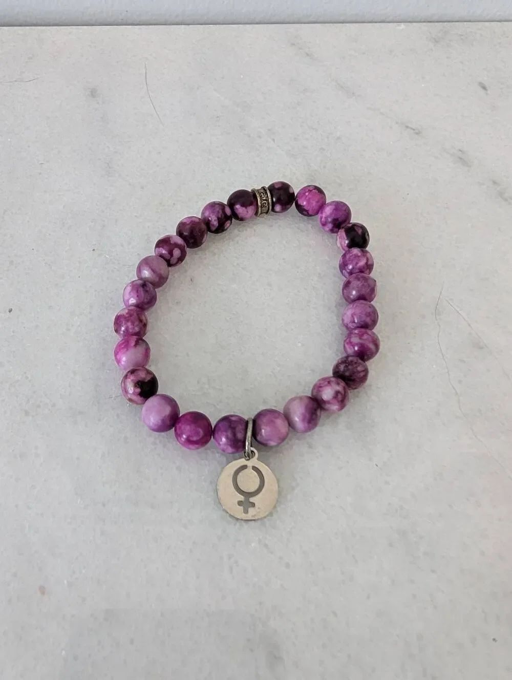 Female Symbol Charm on Purple Beaded Bracelet